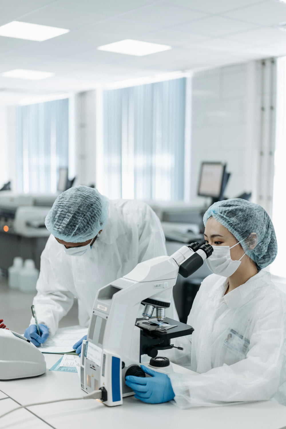 Researchers working with a microscope in a laboratory